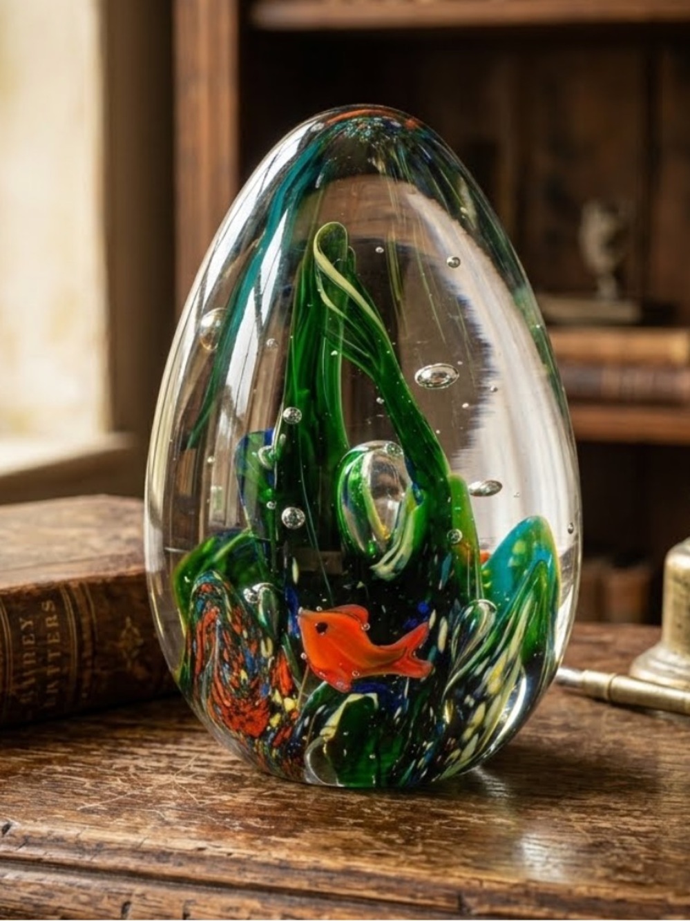 Art Glass Paperweight with Green Swirls and Orange Fish
Like new